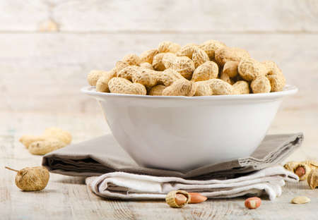 Peanuts on a wooden table.Selective focusの写真素材