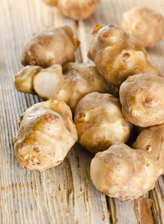 jerusalem artichoke on a wooden table. Selective focusの写真素材
