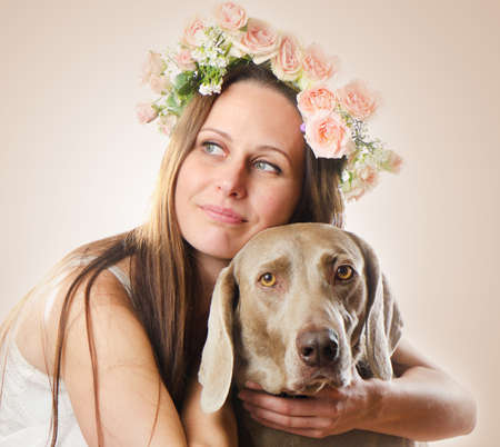 Beautiful smiling woman with dog.Vintage styled  portraitの写真素材