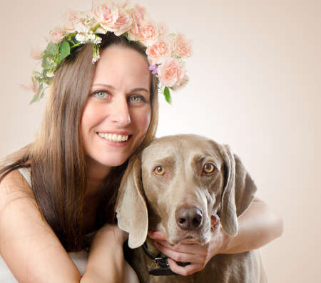 Beautiful smiling woman with dog.Vintage styled  portraitの写真素材
