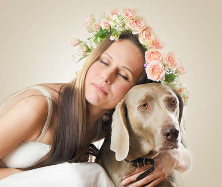 Beautiful smiling woman with dog.Vintage styled  portraitの写真素材