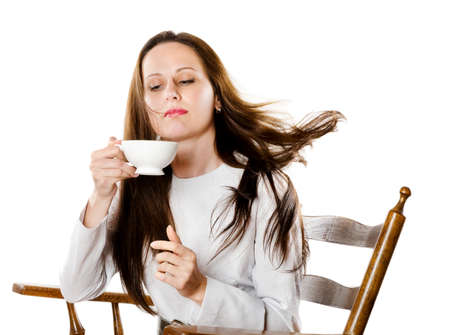young woman drinking coffee isolated on white backgroundの写真素材