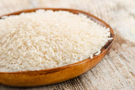 Rice in bowl on a wooden table. Selective focusの写真素材