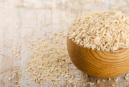 brown rice on a wooden table. Selective focus