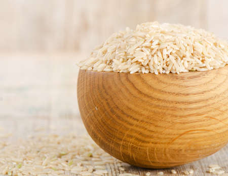 Rice in bowl on a wooden table. Selective focusの写真素材