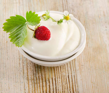 Fresh yogurt with berries on a wooden table  Selective focusの写真素材