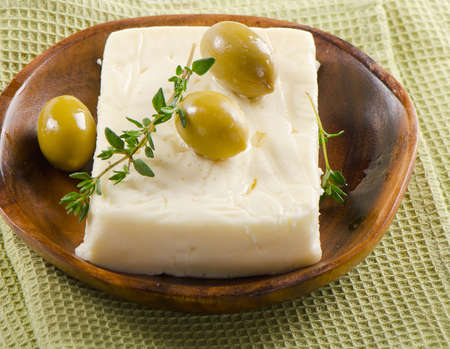 Fresh feta cheese with green olivesの写真素材