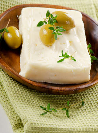 Fresh feta cheese with green olivesの写真素材