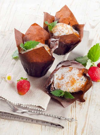Homemade Muffins with  berries on a wooden tableの写真素材