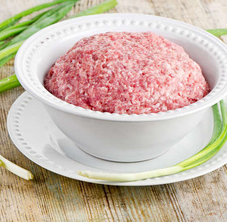 minced meat on a wooden tableの写真素材