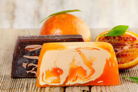 Homemade Soap with fresh orange on a wooden tableの写真素材