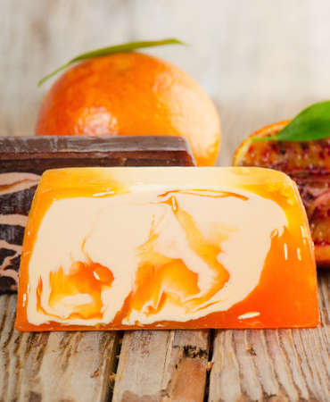 Handmade Soap with fresh orange on a wooden tableの写真素材
