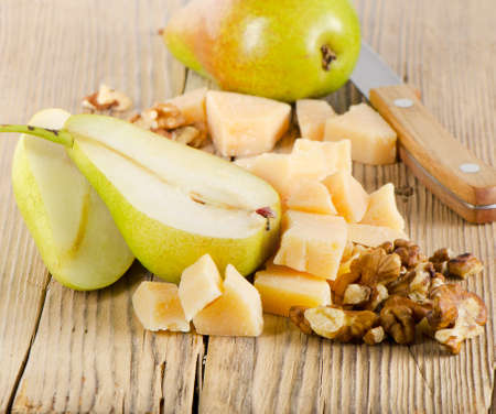 Cheese and pears on a wooden table. Selective focusの写真素材