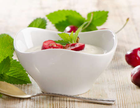 Yogurt with berries on a wooden table. Selective focusの写真素材