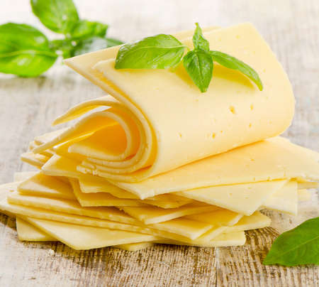 cheese with herbs on a wooden tableの写真素材