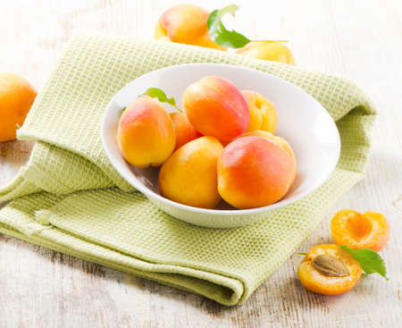 Fresh apricots on a wooden tableの写真素材