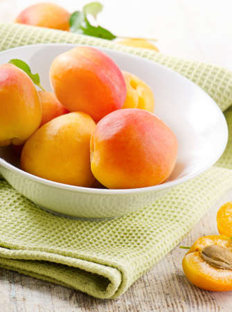 Fresh apricots on a wooden table. Selective focusの写真素材