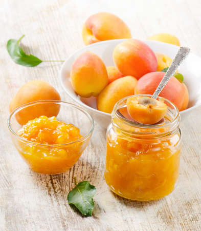 Fresh apricots jam on a wooden table. Selective focusの写真素材