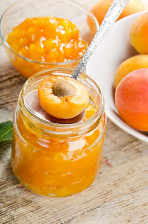 Fresh apricots jam on a wooden table. Selective focusの写真素材