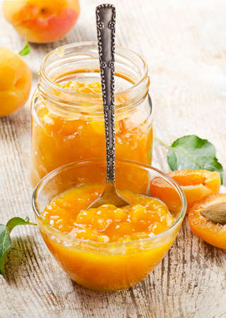 Fresh apricots jam on a wooden table. Selective focusの写真素材