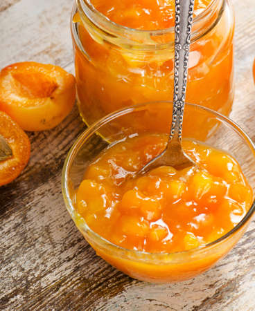Fresh apricots jam on a wooden table. Selective focusの写真素材