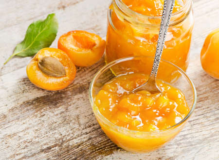 Fresh apricots jam on a wooden table. Selective focusの写真素材
