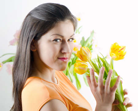 Beautiful happy woman with tulipsの写真素材