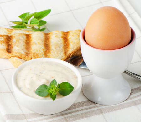 Healthy breakfast - boiled eggs with toast and herbの写真素材