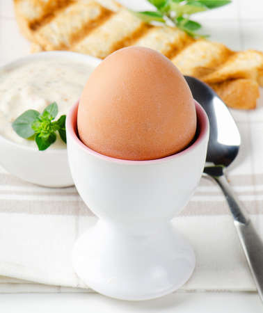 Healthy breakfast - boiled eggs with toast and herbの写真素材