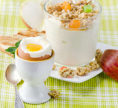 Healthy breakfast - boiled egg , yogurt with muesliの写真素材
