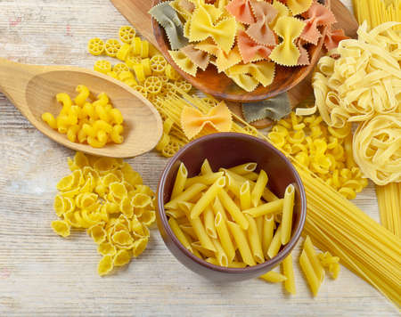 assortment of pasta on a wooden tableの写真素材
