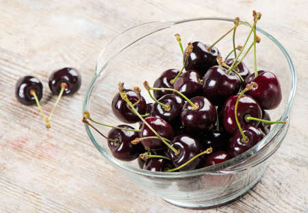 Fresh cherries in glass bowlの写真素材