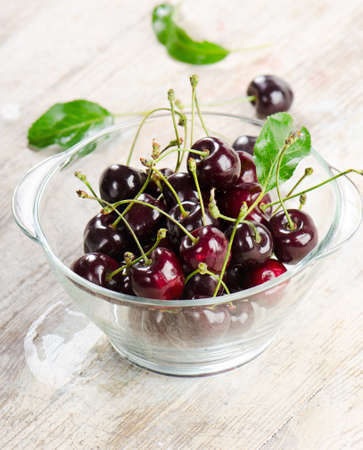 Fresh cherries in glass bowl. Selective focusの写真素材