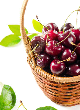 Fresh cherries in the basket isolated on white backgroundの写真素材