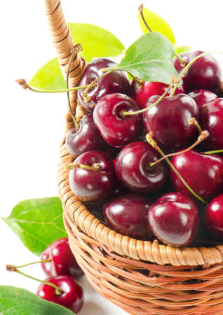 Fresh cherries in the basket isolated on white backgroundの写真素材