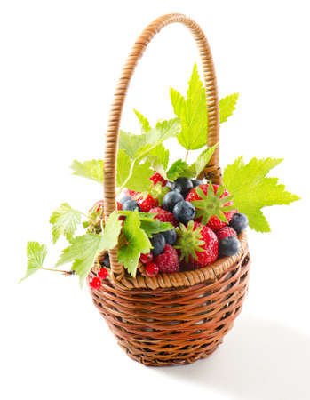 Fresh berries in the basket isolated on white backgroundの写真素材