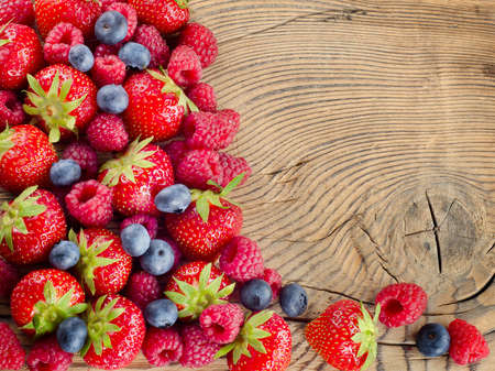 fresh berries on a wooden backgroundの写真素材