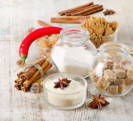 Sugar and spices on a wooden tableの写真素材