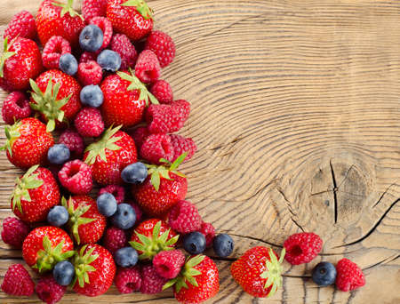 fresh berries on a wooden backgroundの写真素材