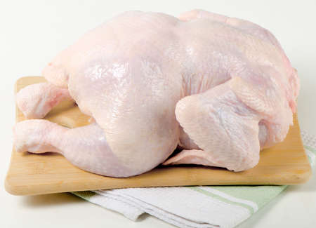 Whole raw chicken の写真素材