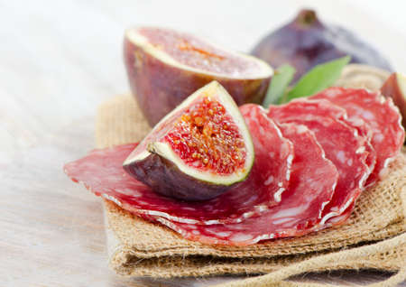 Salami and figs . Selective focusの写真素材