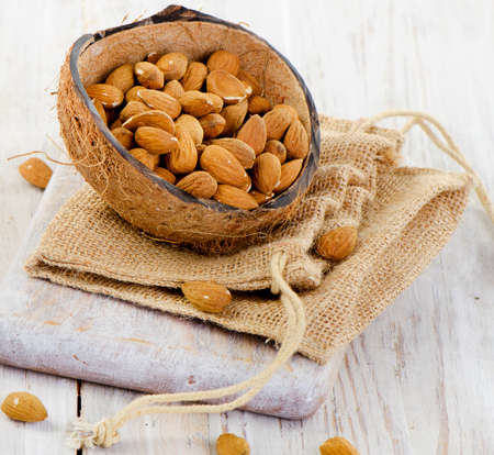 Almonds on wooden table . Selective focusの写真素材