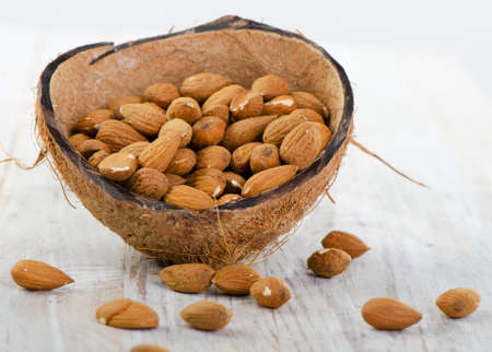 Almonds on wooden table . Selective focusの写真素材
