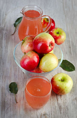 apple juice and apples on wooden tableの写真素材