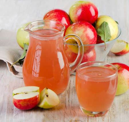 Apple juice and apples on wooden table. Selective focus の写真素材