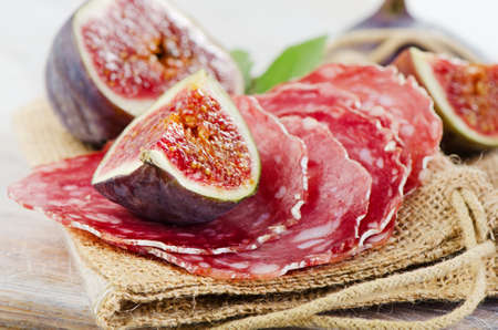 Figs and salami on  wooden table  Selective focusの写真素材