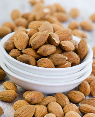 Almonds on wooden table   Selective focusの写真素材