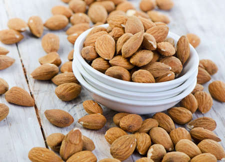 Almonds on wooden table   Selective focusの写真素材