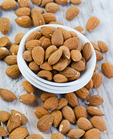 Almonds on wooden table   Selective focusの写真素材