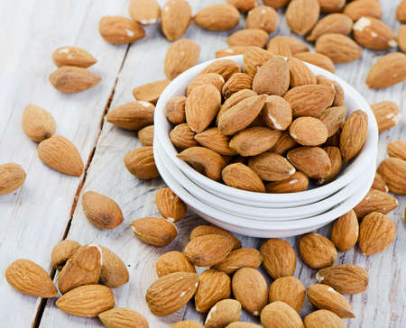 Almonds on wooden table   Selective focusの写真素材